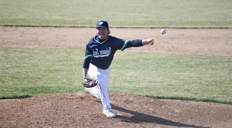 Baseball player John Hines pitching a ball from the pitcher's mound